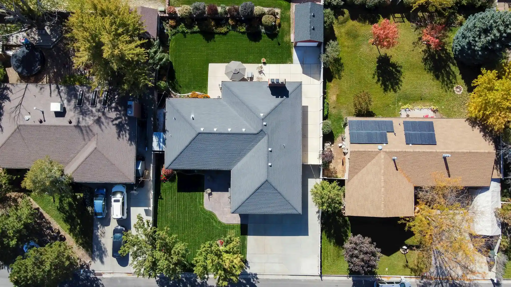 Top down drone photograph of a suburban home centred in its lot, with the roof, driveway, patio, rear lawn, and the property line against both neighbours all visible in one frame. A planned nadir frame like this is the shot an aerial specialist sets up deliberately rather than captures on the way past.
